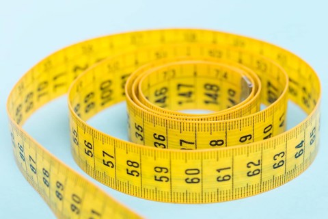 Yellow tape measure blue background