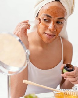 Young woman applying natural face mask 3