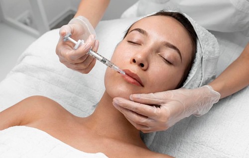 Beautician doing injection filler female client 8