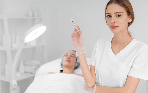 Beautician doing injection filler female client salon 2