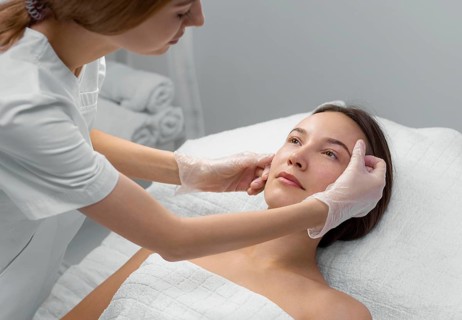 Beautician with female client salon face care routine 3