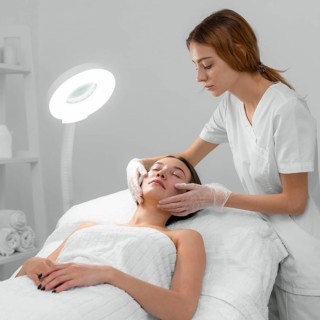 Beautician with female client salon face care routine 4