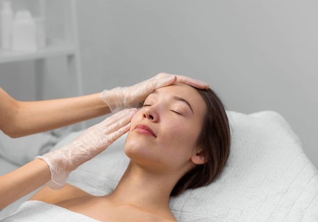 Beautician with female client salon face care routine 7