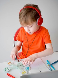 Child wearing headphones e learning concept