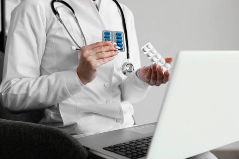 Close up doctor holding pills 2