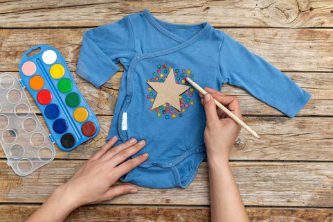 Close up hand drawing baby clothing