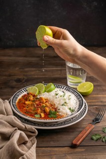 Close up hand squeezing lime juice