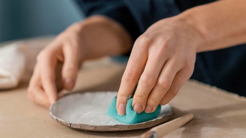 Close up hand using sponge