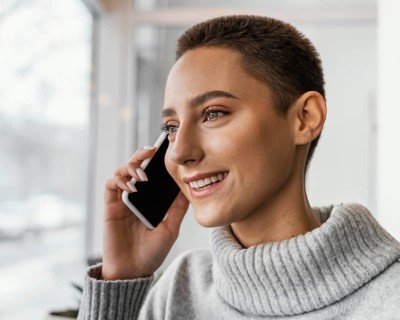 Close up happy woman talking phone