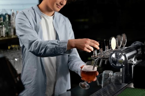 Close up man pouring beer glass