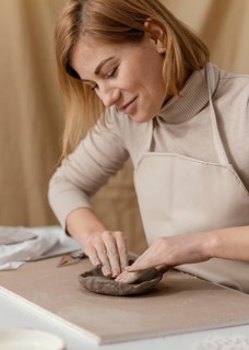 Close up smiley woman doing pottery