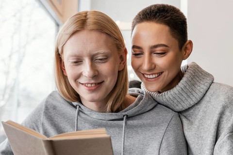Close up women reading together