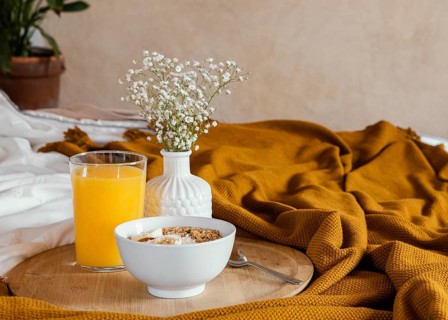 Delicious breakfast with bowl orange juice