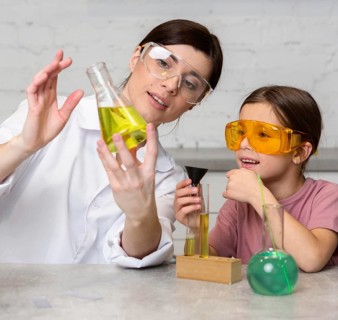 Female teacher girl doing science experiments with test tubes