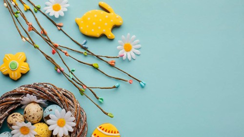 Flat lay easter eggs basket with chamomile flowers bunny