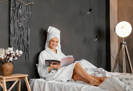Full shot woman reading magazine