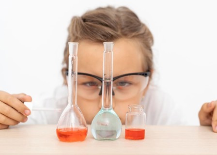 Girl doing chemistry experiments with test tubes