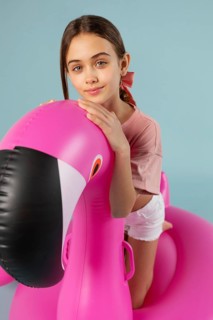 Girl sitting inflatable flamingo