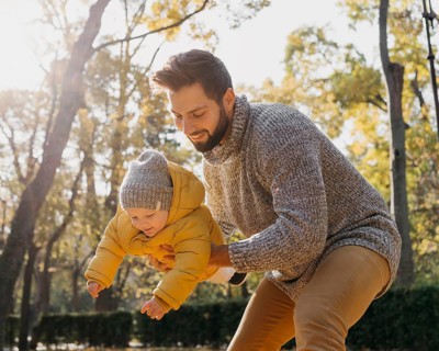 Happy father with baby outdoors