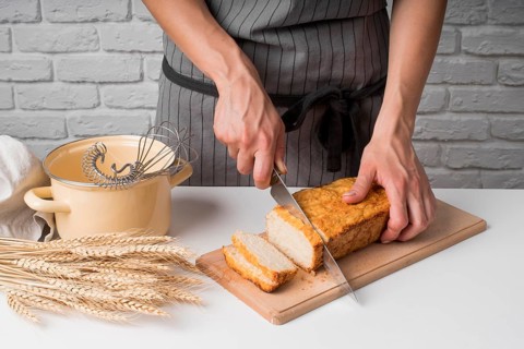 High angle woman slicing banana bread
