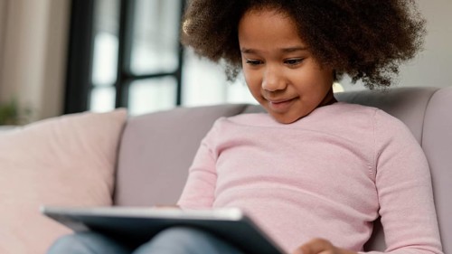 Little girl using tablet home 3