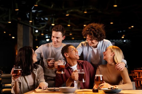 Medium shot happy friends sitting pub