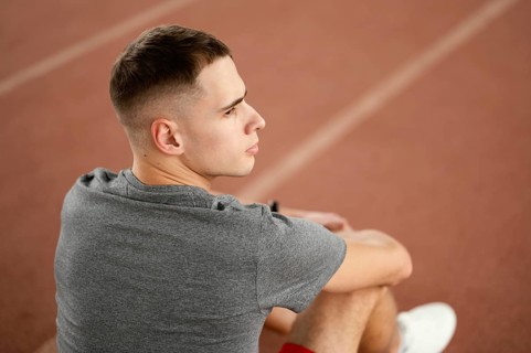 Medium shot man sitting field