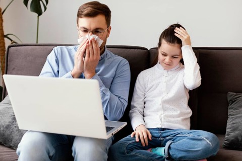 Medium shot sick man with laptop
