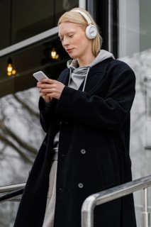 Medium shot woman holding smartphone 3