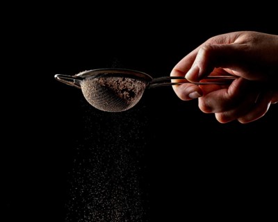 Person using tool chocolate cake