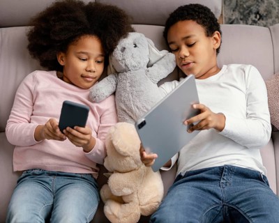 Siblings using tablet mobile home
