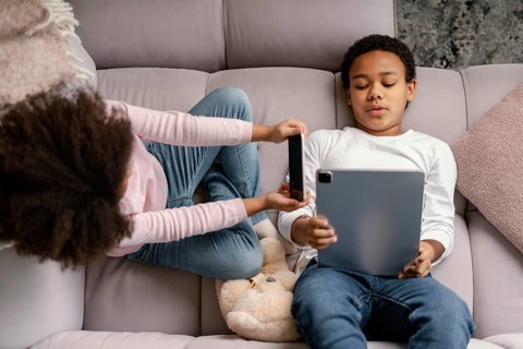 Siblings using tablet mobile home 4