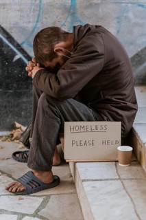 Side view homeless man stairs with cup help sign