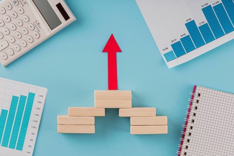 Top view business items with growth chart arrow