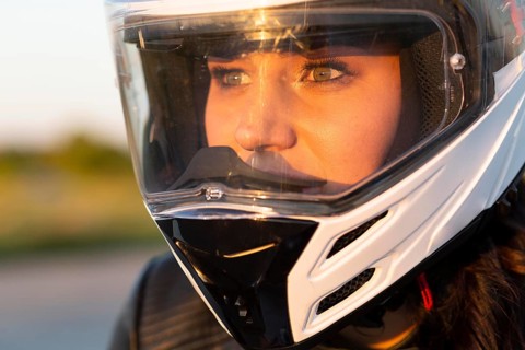 Woman riding her motorcycle with helmet