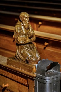 Praying figure on a church bench
