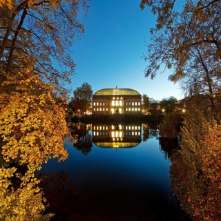 The Staendehaus K21 is reflected in the Kaiserteich in autumn in the evening