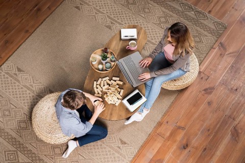 Top view mother working from home her son