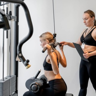 Young woman exercising gym side view