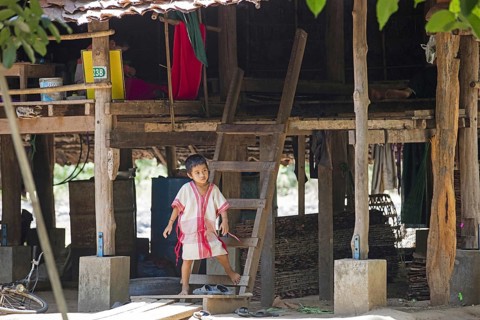Bamar child in front of pile dwelling in Kayin village near the town of Hpa-an