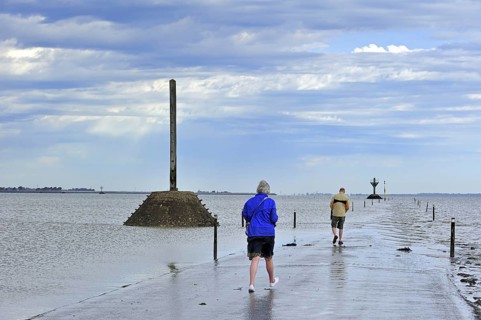 Tourists waiting for low tide to uncover the Passage du Gois