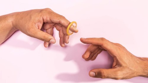 Close up man hands with transparent condom
