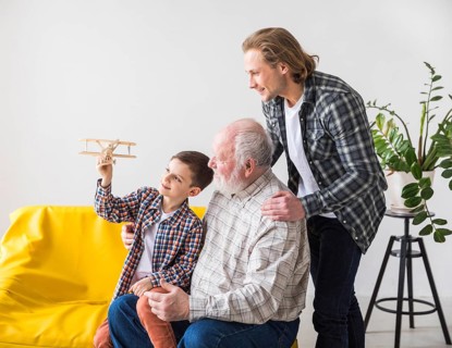 Men different generations looking toy plane