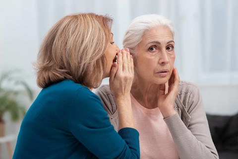 Portrait mature women whispering
