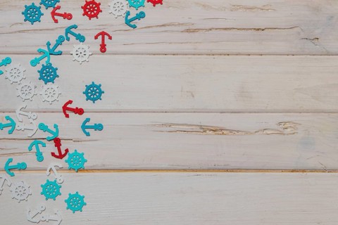 White wooden surface with colored summer items