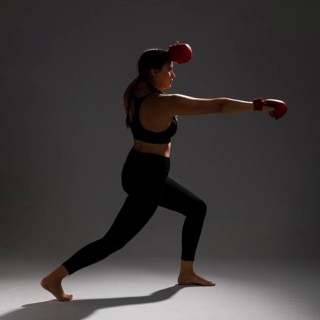 Woman sideways punching with box gloves