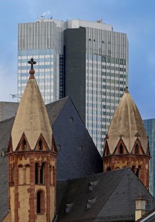 Old Catholic church of St Leonhard in front of modern skyscrapers