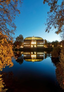 The Staendehaus K21 is reflected in the Kaiserteich in autumn in the evening