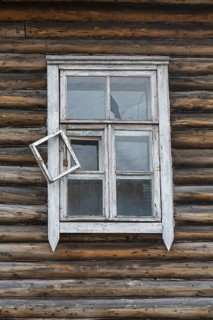 Window of derelict wooden building at Pyramiden