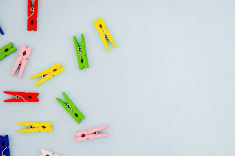Flat lay colorful clothes pins with copyspace